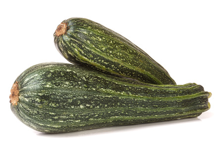 Two green zucchini isolated on white background.の写真素材
