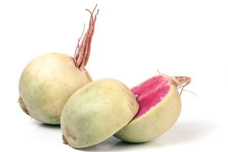 One whole and sliced watermelon radish isolated on white background.