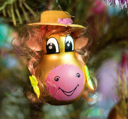 yellow cow hanging on the Christmas tree closeup.の写真素材
