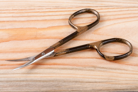 nail scissors on a light wooden backgroundの写真素材