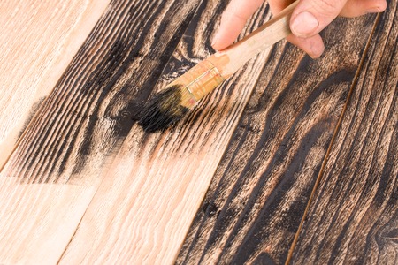 painting wooden board paint brush in black colorの写真素材