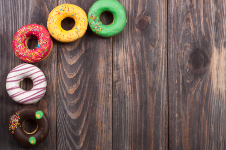 glazed donuts on a black wooden background with copy space for your text. Top viewの写真素材