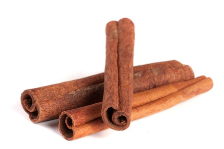 three cinnamon sticks isolated on white backgroundの写真素材