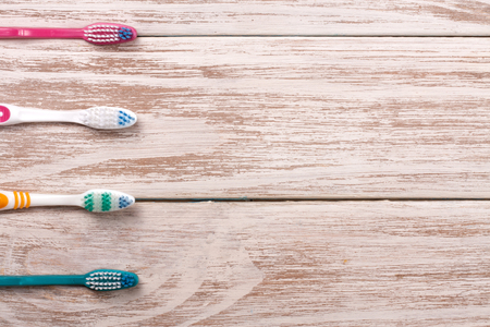 manual toothbrushes on the old wooden background with copy space for your text. Top viewの写真素材