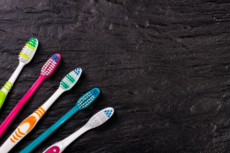 manual toothbrushes on the black background with copy space for your text. Top viewの写真素材