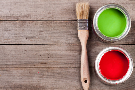 green and red paint in the bank with brush on the old wooden background with copy space for your text. Top viewの写真素材