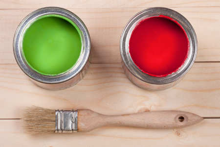 green and red paint in the bank to repair and paint brush on the light wooden background .の写真素材