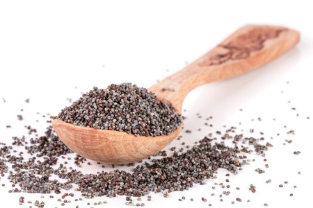 poppy seeds in a wooden spoon isolated on white backgroundの写真素材