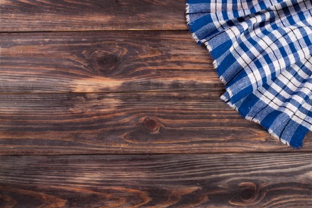 blue checkered tablecloth on the black wooden table with copy space for your text. Top view.の写真素材