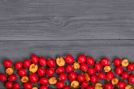 Hawthorn berry on a black wooden background with copy space for your text. Top view.の写真素材
