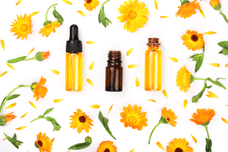 aromatherapy essential oil with marigold flowers isolated white backgroundの写真素材