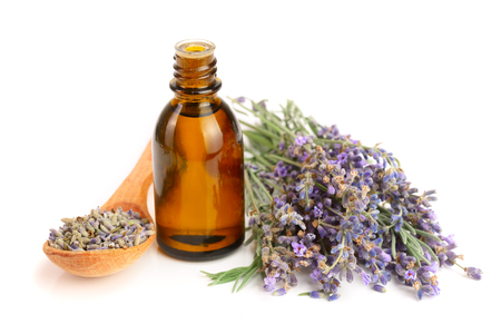 Bottle with aroma oil and lavender flowers isolated on white backgroundの写真素材