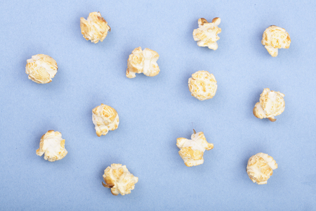Popcorn on blue background. Top view. Flat lay patternの写真素材