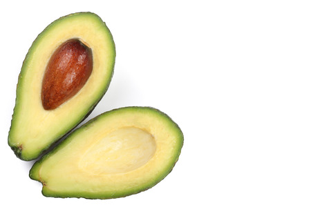 whole and half avocado isolated on white background close-up with copy space for your text. Top...
