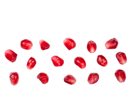 pomegranate seeds isolated on white background with copy space for your text. Top view. Flat lay...