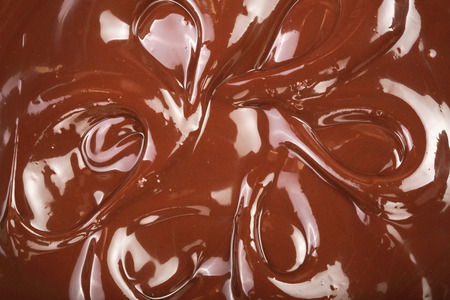 Melted chocolate swirl as a background closeupの写真素材