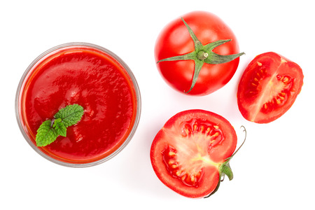 Tomato juice in glass and tomatoes isolated on white background. Top view. Flat layの写真素材