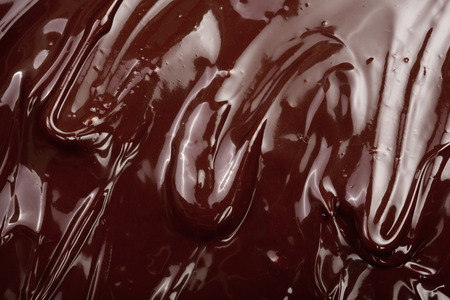 Melted chocolate swirl as a background closeupの写真素材