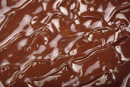 Melted chocolate swirl as a background closeupの写真素材