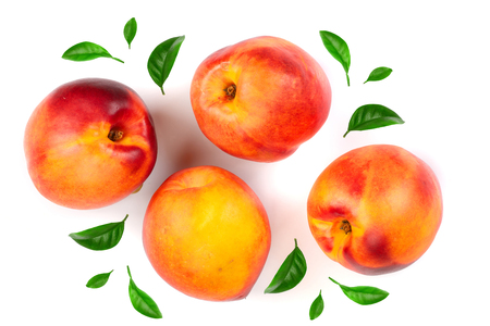 ripe nectarine with leaves isolated on white background. Top view. Flat lay pattern.の写真素材