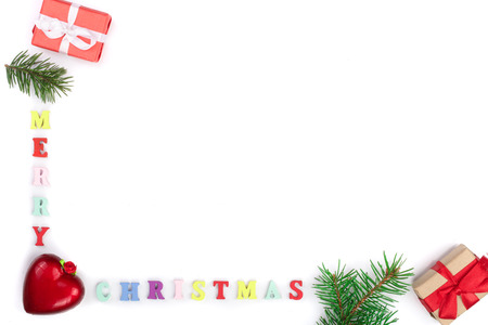 Merry Christmas inscription in a frame made of fir branches, festive decorations isolated on white backgroundの写真素材