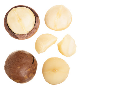 Shelled and unshelled macadamia nuts isolated on white background with copy space for your text. Top view. Flat lay pattern.の写真素材