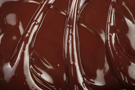 Melted chocolate swirl as a background closeupの写真素材