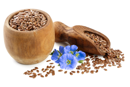 flax seeds in wooden scoop and bowl with flower isolated on white background.の写真素材