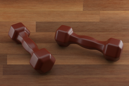 3d rendering dumbbell on the wooden floor, closeup, for fitness or weight related themes.の写真素材