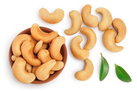 Roasted Cashew nuts in wooden bowl isolated on white background  and full depth of field. Top view. Flat layの写真素材