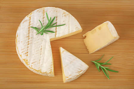 Camembert cheese on wooden background with full depth of field. Top view. Flat layの写真素材