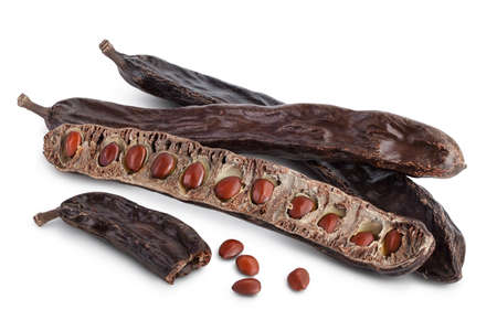 Ripe carob pods and bean isolated on white background with clipping path and full depth of field