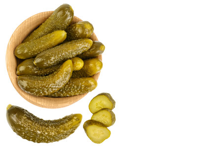 Marinated pickled cucumber in wooden bowl isolated on white background. Top view with copy space for your text . Flat layの写真素材