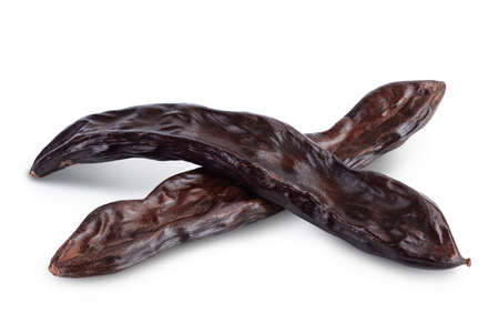 Ripe carob pods isolated on white background with and full depth of fieldの写真素材