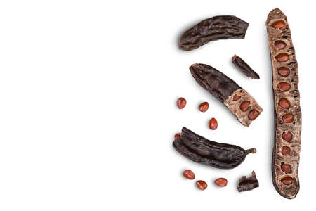 Ripe carob pods and bean isolated on white background with . Top view with copy space for your text. Flat layの写真素材