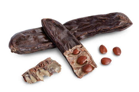 Ripe carob pods and bean isolated on white background with clipping path and full depth of field