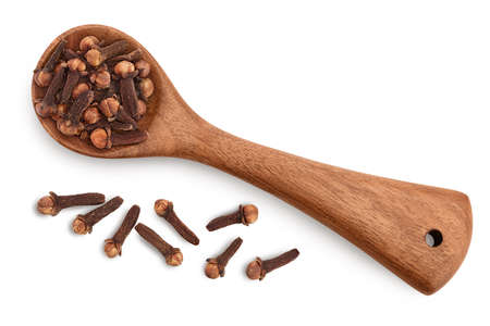 Dry spice cloves in wooden spoon isolated on white background  . Top view. Flat layの写真素材