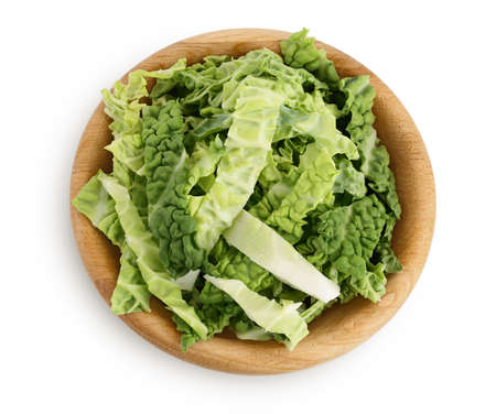 chopped savoy cabbage in wooden bowl isolated on white backgroundの写真素材