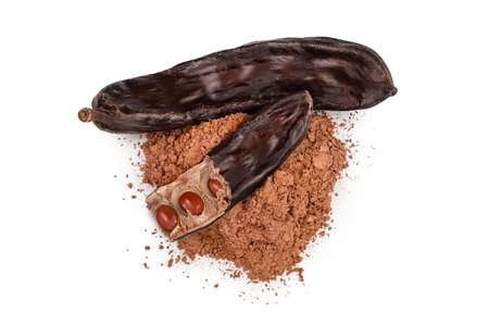Carob pod and powder isolated on white background with clipping path and full depth of field. Top view. Flat layの写真素材
