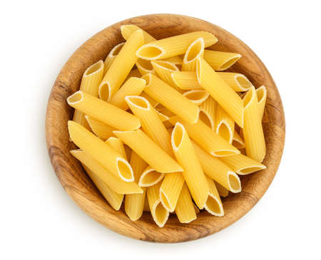 Raw italian penne rigate pasta in wooden bowl isolated on white background with clipping path and...