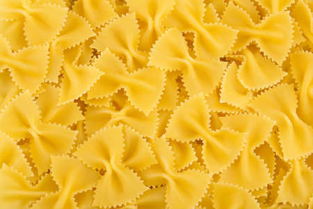 Bow tie pasta background. Top view. Flat lay.