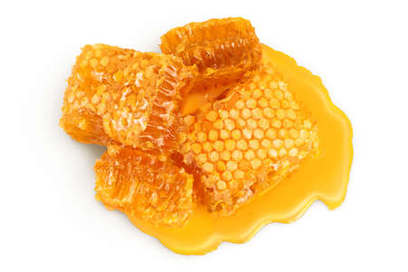 Honeycombs and honey puddle isolated on white background with clipping path and full depth of field....