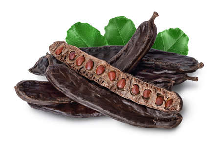 Ripe carob pods and bean isolated on white background with clipping path and full depth of field