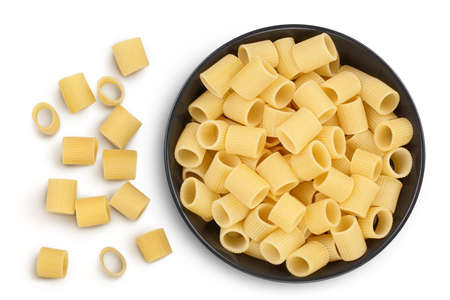 raw italian pasta in ceramic bowl isolated on white background with clipping path . Mezze Maniche Rigate Bronze die. Top view. Flat lay.の写真素材