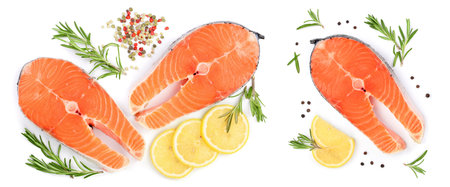 Slice of red fish salmon with lemon, rosemary and peppercorns isolated on white background. Top view. Flat layの写真素材