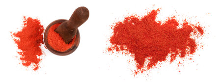 Paprika powder in a wooden bowl with a scoop isolated on white background. Top viewの写真素材