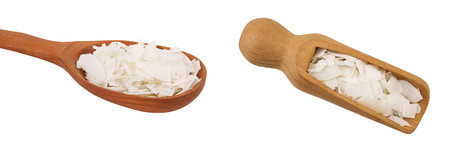 Coconut flakes or chips in wooden scoop isolated on white background. Top view. Flat layの写真素材