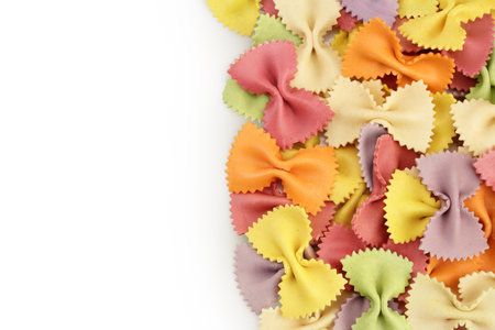 colorful farfalle pasta isolated on white background . Top view with copy space for your text. Flat lay.の写真素材