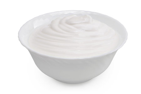 sour cream or yogurt in ceramic bowl isolated on white background with full depth of fieldの写真素材