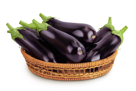 eggplant in a wicker basket isolated on white background with full depth of fieldの写真素材